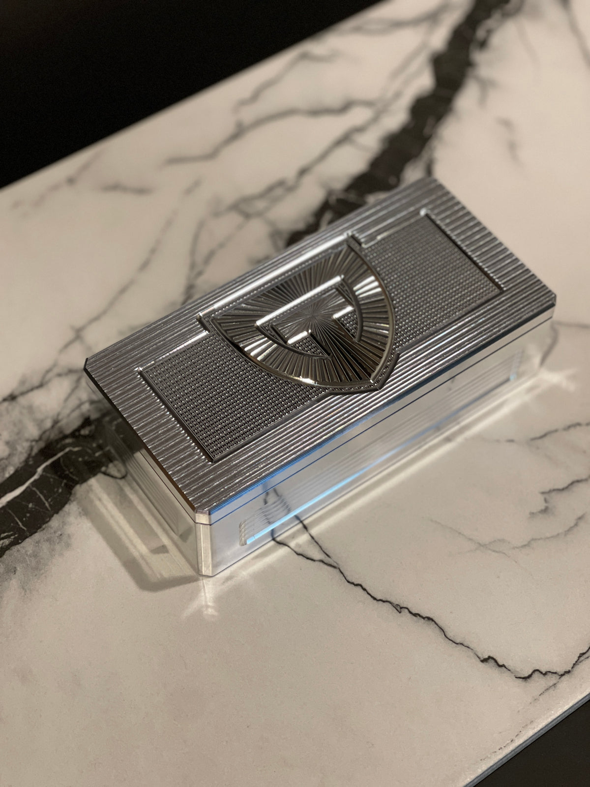 Closed TRT Vault Micro in Raw Machined on a marble countertop.