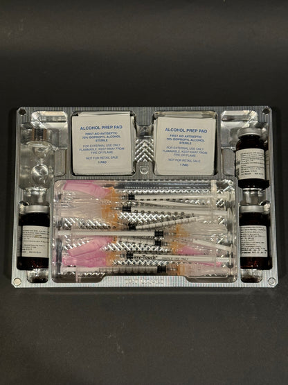 Raw machined TRT Vault Mega shown open, no lid, with syringes, vials, alcohol pads, and storage supplies.