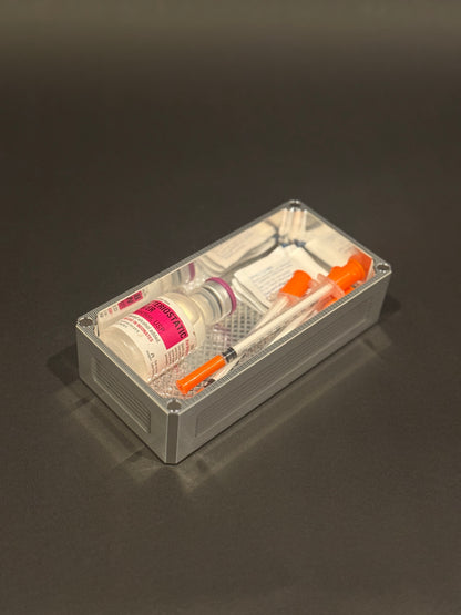 Raw machined Flex Vault Micro Lidless holding syringes, alcohol swabs and a vial.