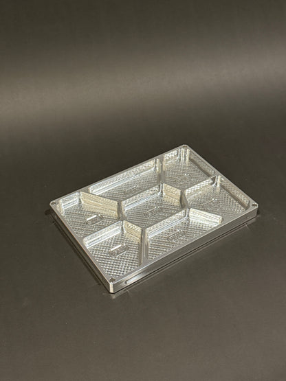 Raw machined Vitamin Vault Mega Lidless shown empty with seven labeled daily compartments.