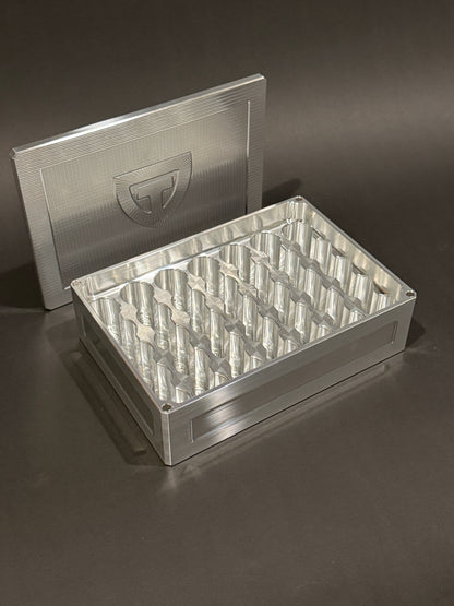 Raw machined Vial Vault Mega shown open and empty with magnetic lid and precision-machined vial storage slots.