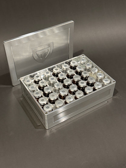 Raw machined Vial Vault Mega shown open and filled with assorted vials, with the magnetic lid behind it.