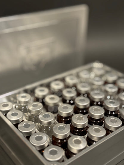 Close-up of raw machined Vial Vault Mega shown open and filled with assorted vials, with the magnetic lid behind it.