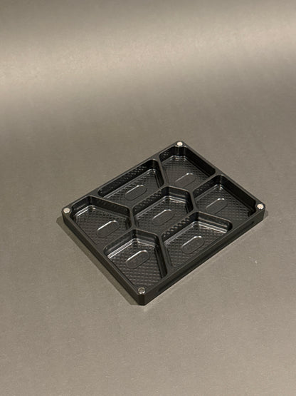 Anodized black Vitamin Vault Mini Lidless shown empty with seven individual storage compartments.