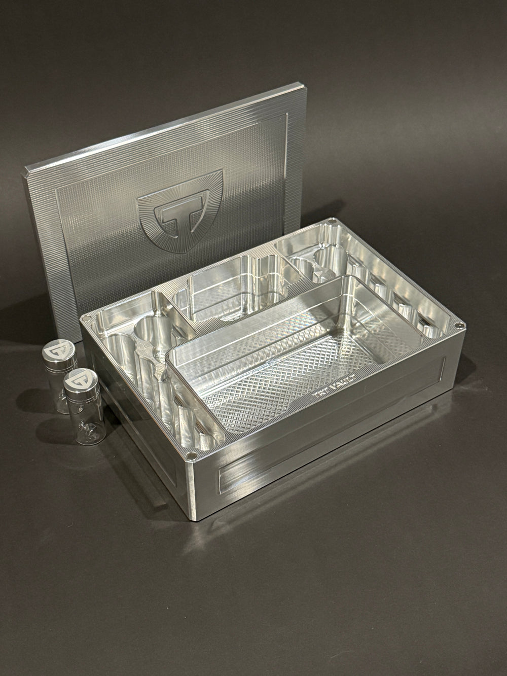 Raw Machined Cycle Vault Mega shown open with its magnetic lid behind it and two included pill vials beside it.