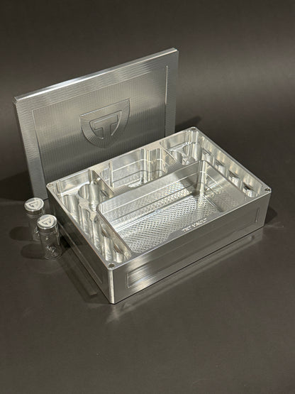 Raw Machined Cycle Vault Mega shown open with its magnetic lid behind it and two included pill vials beside it.