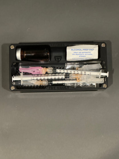Open TRT Vault Micro in Anodized Black holding a 5-10 mL vial, syringes and alcohol swabs.