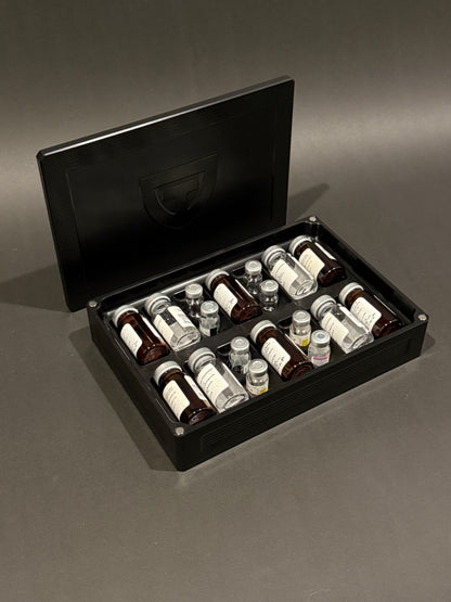 Anodized black Peptide Vault Mega shown open and filled with assorted peptide vials, with the magnetic lid behind it.