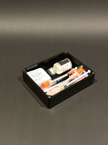 Anodized black Flex Vault Mini Lidless filled with vials, syringes, and injection supplies.