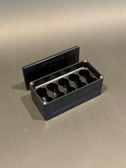 Black anodized Vial Vault Micro shown open with magnetic lid, displaying upright vial storage slots.