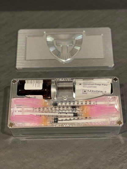 Open TRT Vault Micro in Raw Machined holding a 5-10 mL vial, syringes and alcohol swabs.
