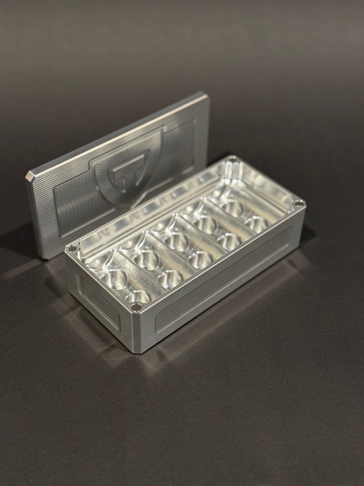 Raw aluminum Peptide Vault Micro shown open and empty, displaying its vial storage slots.