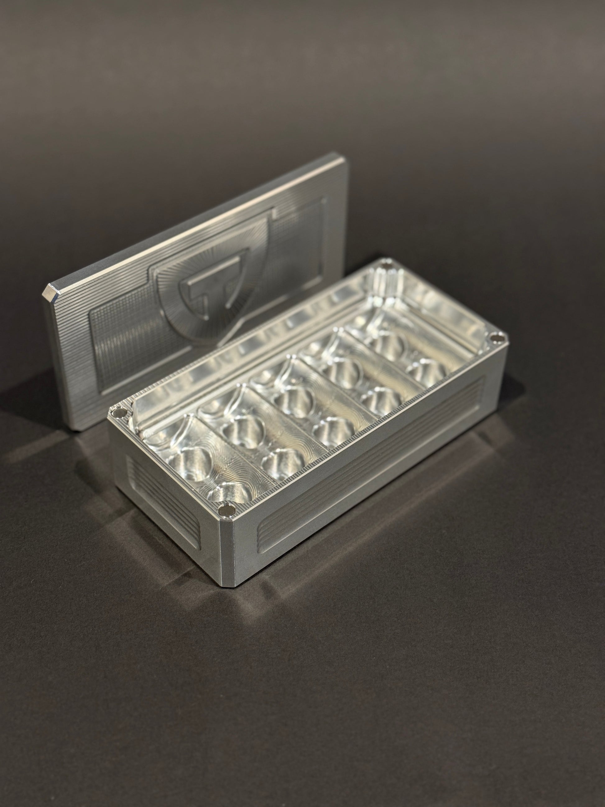 Raw aluminum Peptide Vault Micro shown open and empty, displaying its vial storage slots.