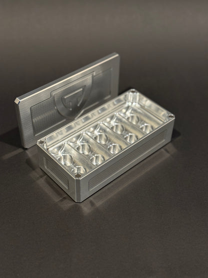 Raw aluminum Peptide Vault Micro shown open and empty, displaying its vial storage slots.