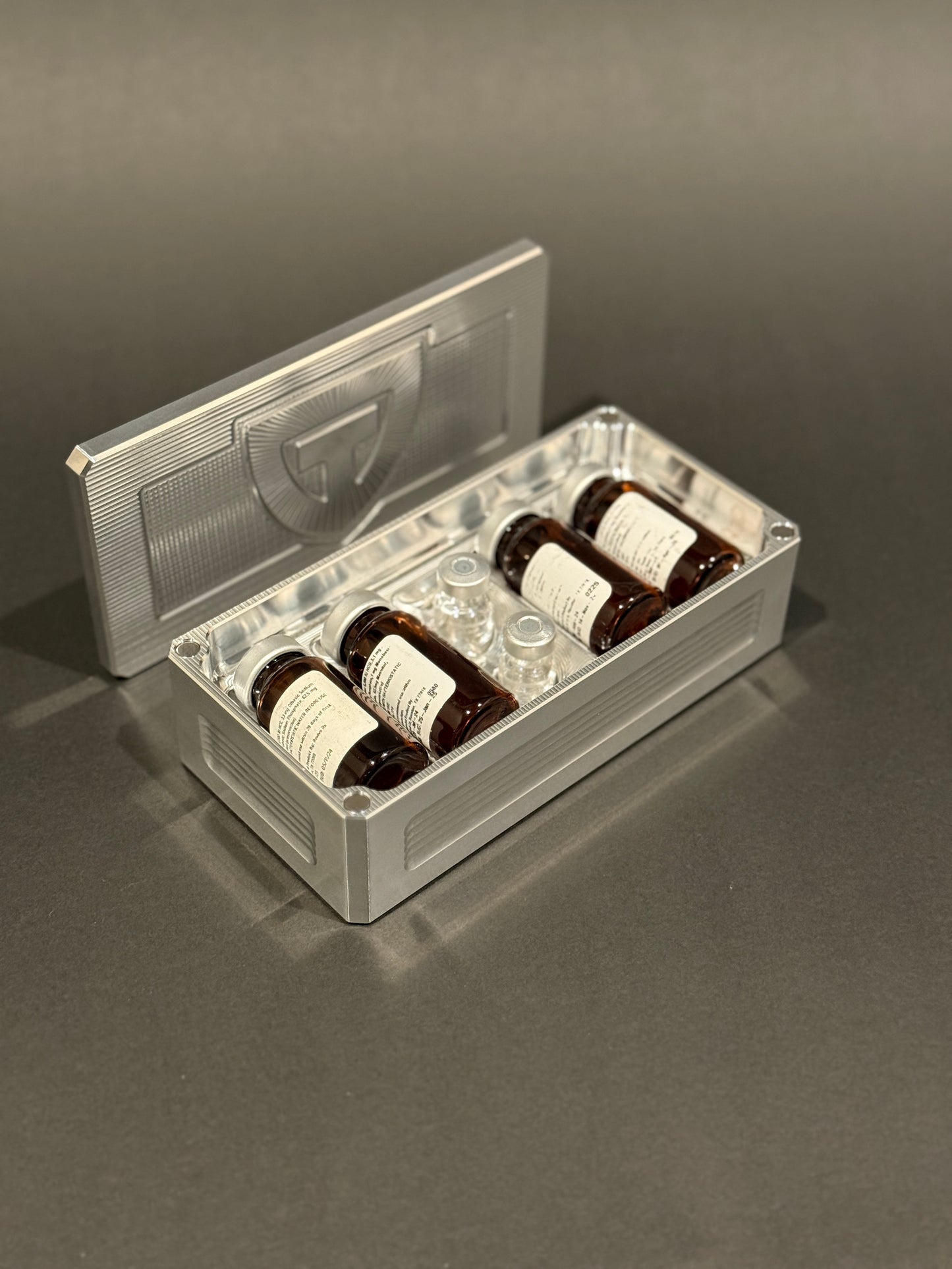 Raw aluminum Peptide Vault Micro shown open and loaded with peptide vials.