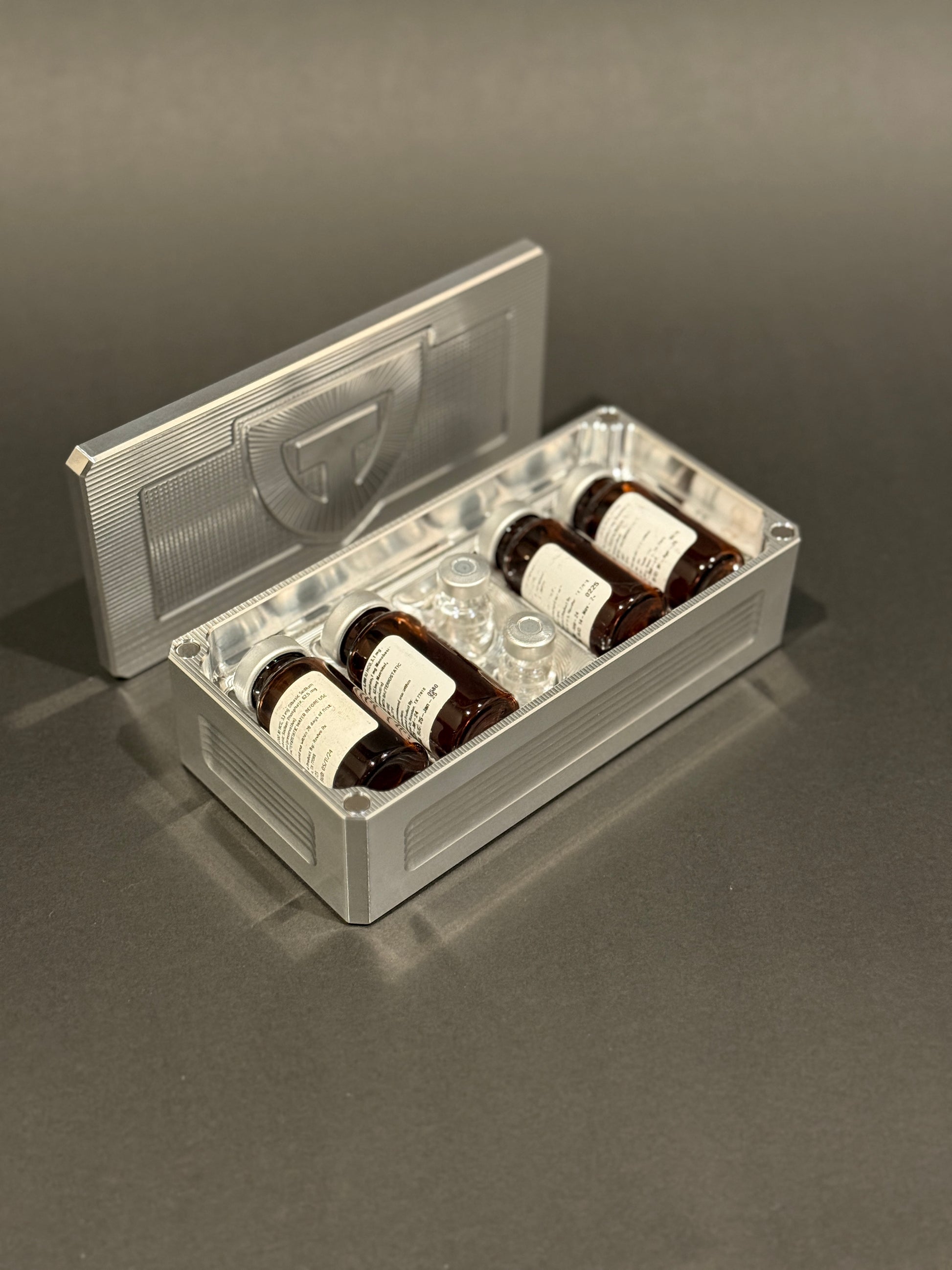 Raw aluminum Peptide Vault Micro shown open and loaded with peptide vials.