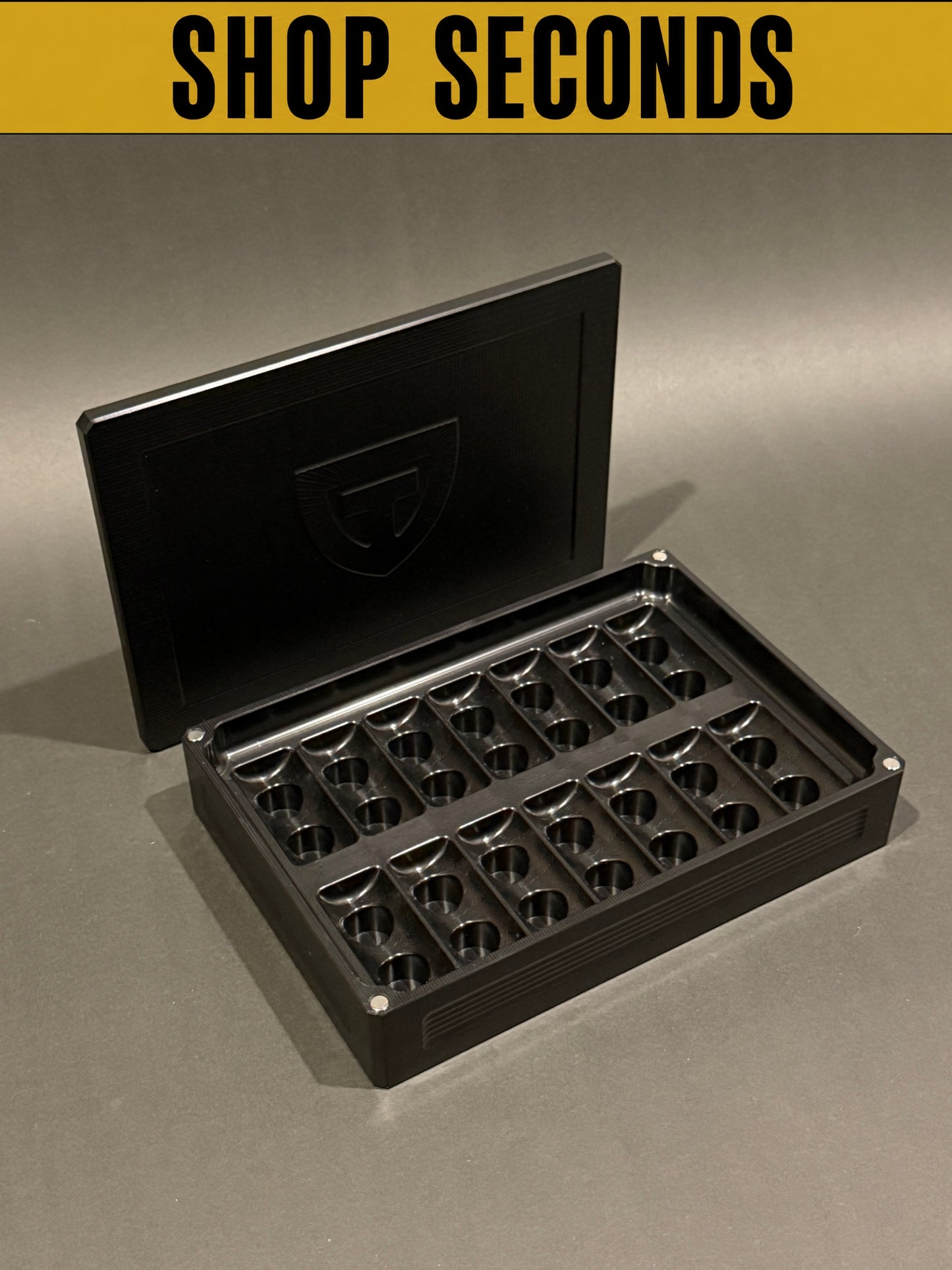 Shop Seconds anodized black Peptide Vault Mega shown open and empty with magnetic lid and precision-machined vial storage slots.