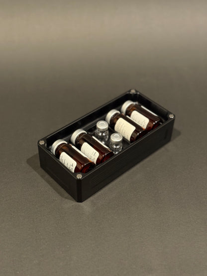 Anodized Black Peptide Vault Micro Lidless shown filled with assorted peptide vials.
