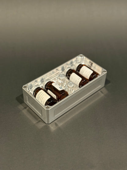 Raw machined Peptide Vault Micro Lidless shown filled with assorted peptide vials.