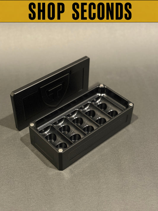 Shop Seconds black anodized Peptide Vault Micro shown open and empty with magnetic lid, displaying vial storage slots.