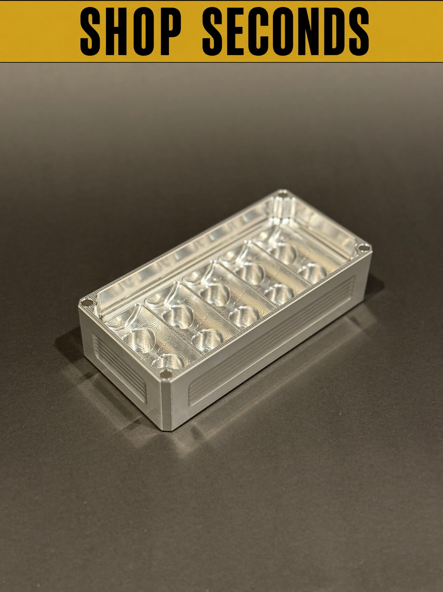 Shop Seconds Peptide Vault Micro in raw machined aluminum, shown empty with precision-cut vial compartments.