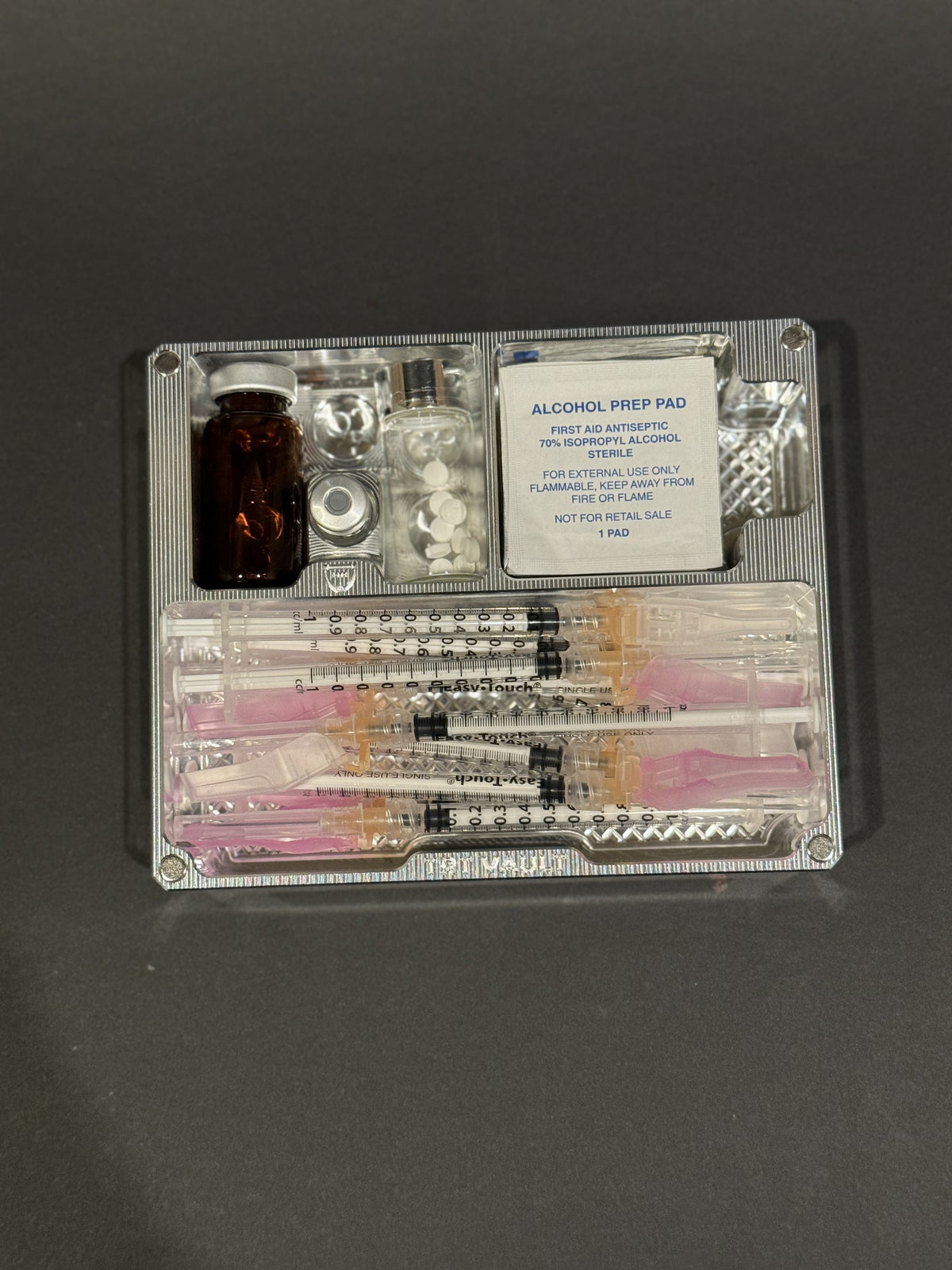 Open TRT Vault Mini in Raw Machined holding vials, syringes, alcohol swabs and pill vial.