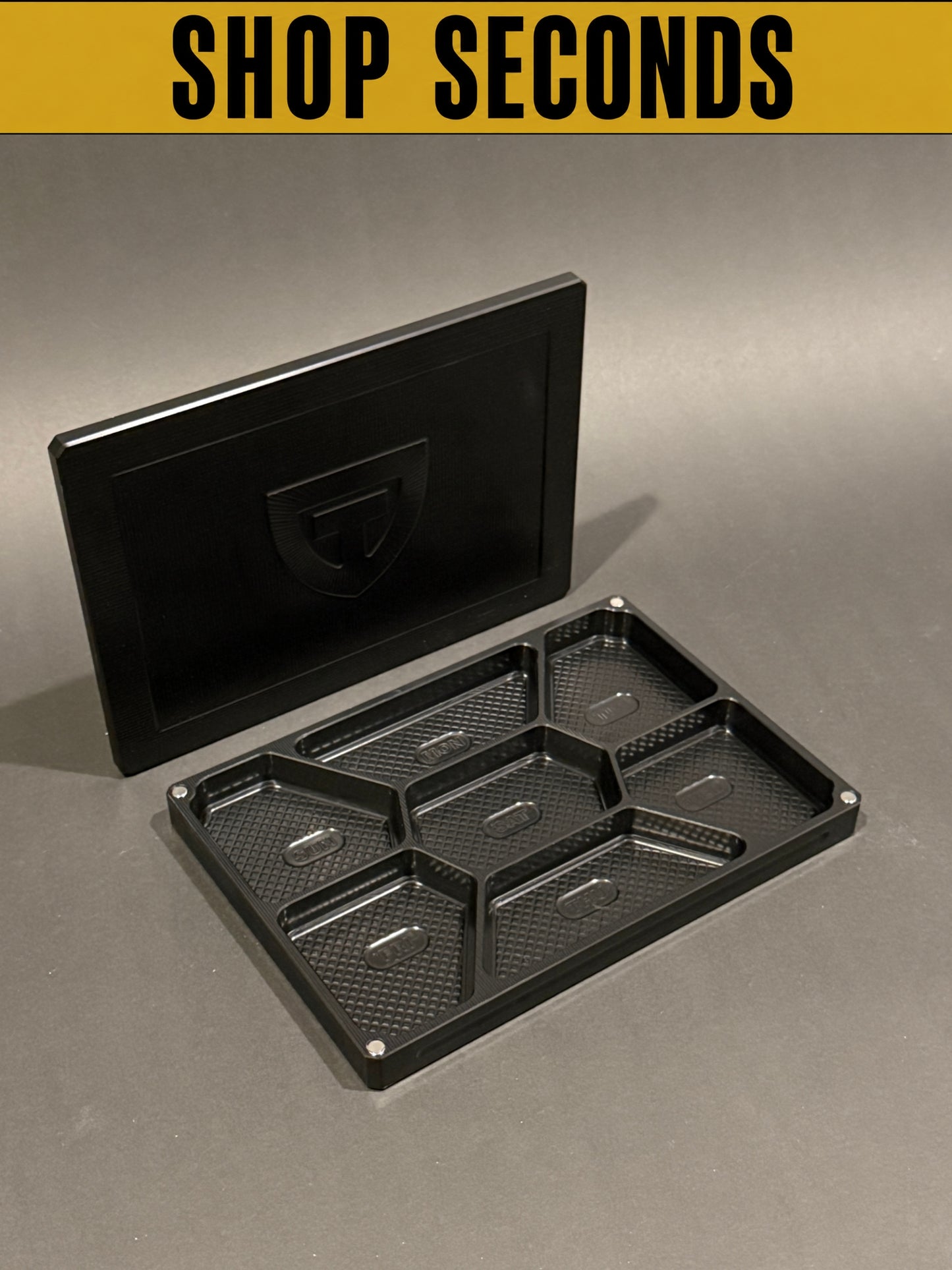 Shop Seconds anodized black Vitamin Vault Mega shown open and empty with its magnetic lid.