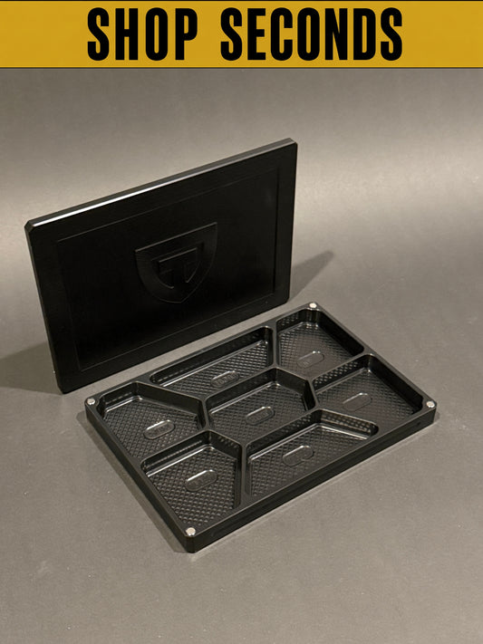 Shop Seconds anodized black Vitamin Vault Mega shown open and empty with its magnetic lid.