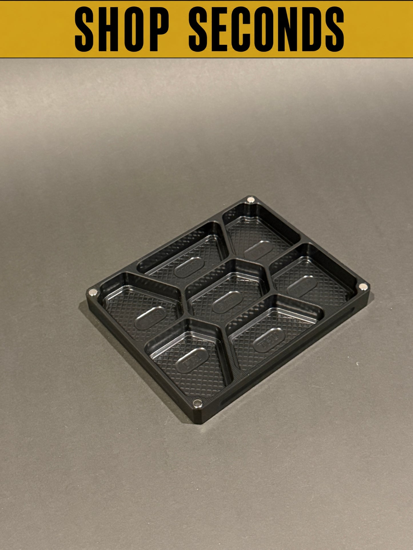 Shop Seconds anodized black Vitamin Vault Mini Lidless shown empty with seven individual storage compartments.