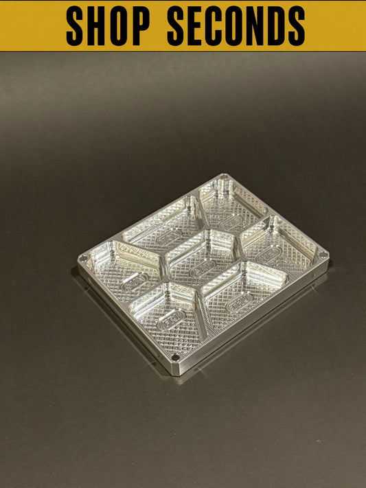 Shop Seconds raw machined Vitamin Vault Mini Lidless shown empty with seven individual storage compartments.