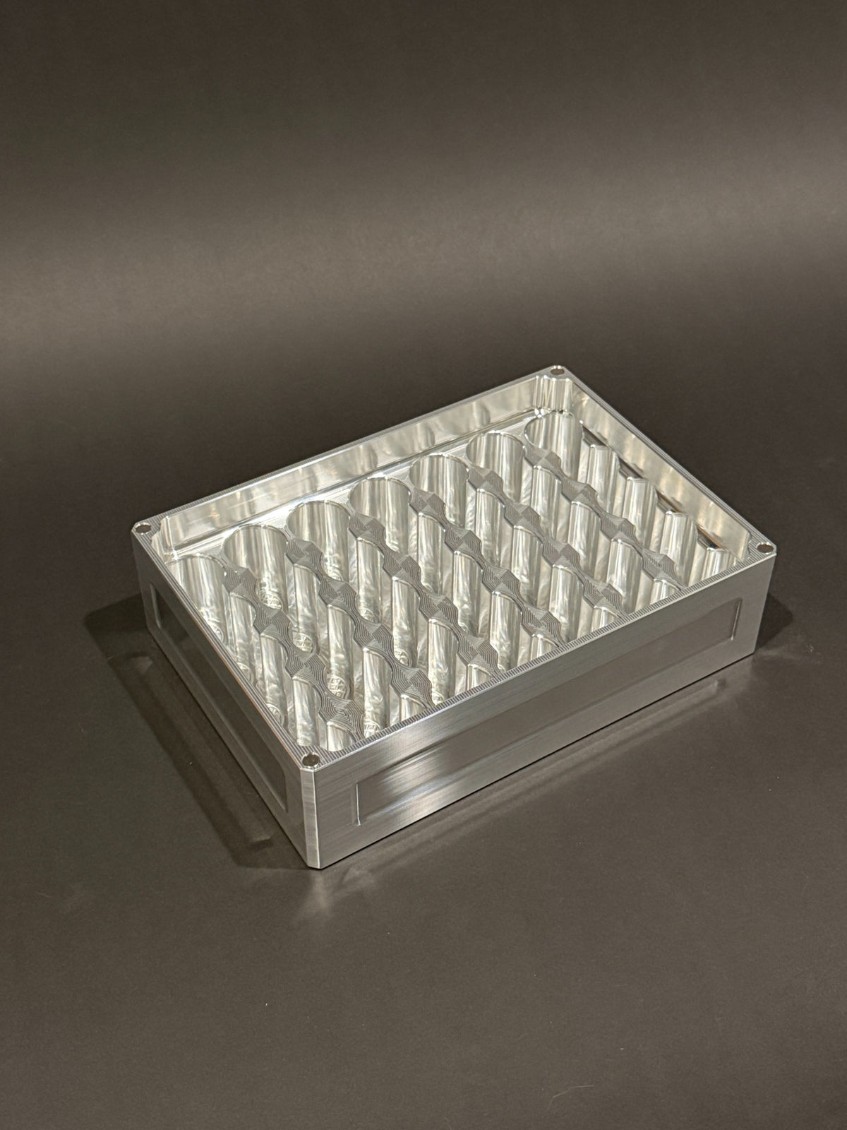 Lidless Vial Vault Mega in Raw Machined, shown empty with precision-machined upright vial storage slots.
