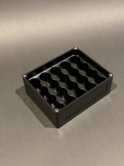 Lidless Vial Vault Mini in Anodized Black, shown empty with precision-machined upright vial storage slots.